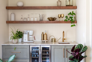 Stylish kitchen wet bar with floating shelves above