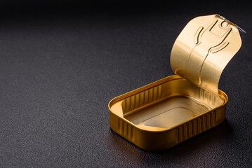 Metal aluminum opened can of canned sardines in oil with spices and salt