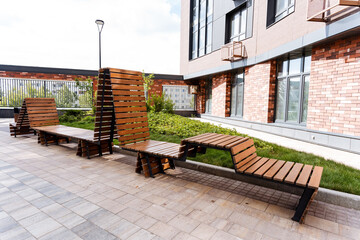 The brick building has wooden benches outside, providing a serene spot for visitors to unwind in...