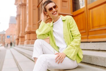 Happy pretty short-haired woman walks outside. Lifestyle, fashion, travel concept.