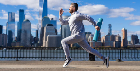 Sportsman jogger running. Sport runner in Manhattan. The sportsman running at view to New York. Man sportsman running for exercise in active wear. Advertisement