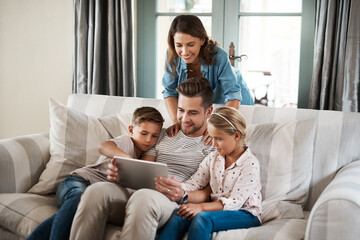 Parents, kids and happy with tablet in home on sofa for education games, cartoon and entertainment. People, family and smile on couch in living room with fun videos for child or brain development