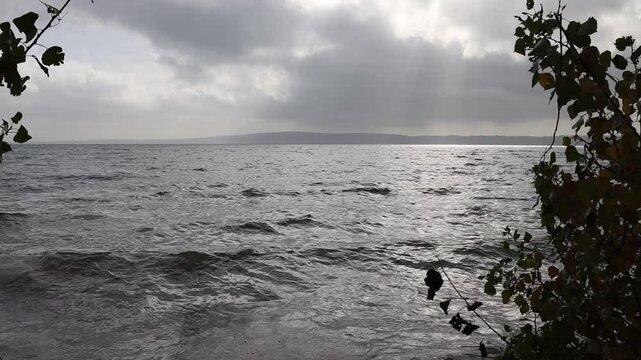 Waves on a lake coastline in Italy. Lake Bracciano, Italy - Lago Bracciano, Italia. Natural seascape. Stop motion moving image clip mp4.	 
