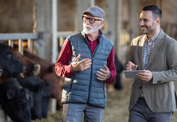 Businessman and farmer talking on ranch