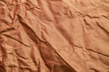 Silk golden crumpled fabric texture closeup as textile background