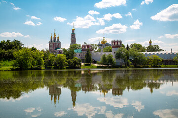 View of the Novodevichy Monastery with a pond on a clear sunny day. Sights of Moscow, World tourism.