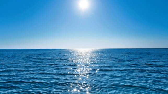 Serene Ocean Horizon Under Clear Blue Sky with Glistening Sun Reflection