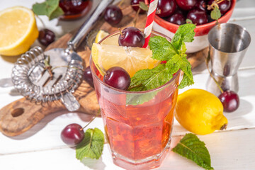 Summer cold refreshment cocktail with cola cherry juice. Cherry cola lemonade or mojito