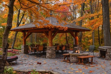 Fototapeta premium Garden gazebo with fire pit, surrounded by chairs and table in the woods, stone walls on sides of roof, large wooden canopy over entire structure, paver patio under it, autumn colors Generative AI