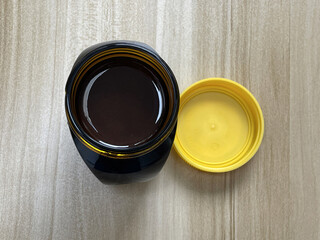 Open jar of yeast extract spread on kitchen table
