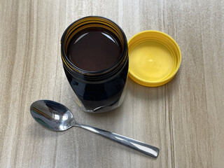 Open jar of yeast extract spread on kitchen table
