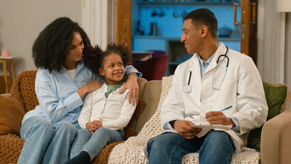 Happy African American mother daughter doctor woman man girl smiling medicine child pediatrician...