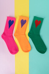 Different color socks with heart. advertising, logo, branding.