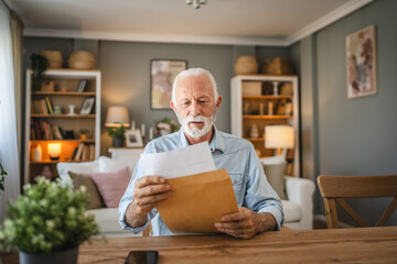 Senior man open and read a letter document from envelope good news
