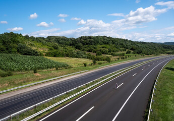 Empty open highway through pastoral landscape