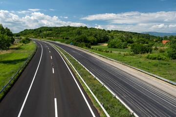 Empty open highway through pastoral landscape