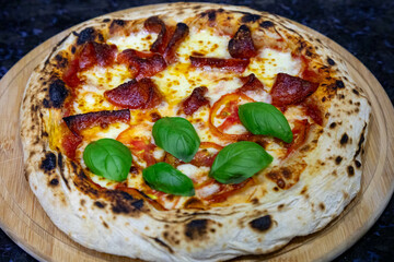 Authentic rustic artisan pizza vera Neapolitan pizza, half peperoni and half margherita