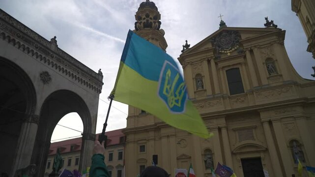 Munich. Germany. Odeonsplatz muenchen. Subject of war between Russia and Ukraine. Protesters holding yellow and blue and European Union flags at demonstration against war in Bayern. 
