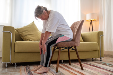 Senior caucasian woman doing doing yoga at home on sofa © Viktor Koldunov