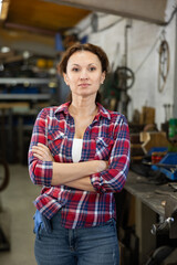 Adult female worker posing at work in oak workshop