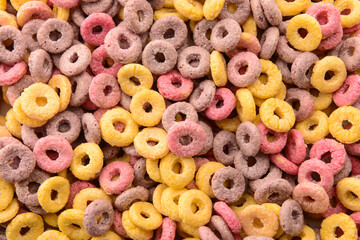 Texture of colorful sweet cereal rings as background