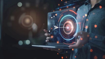 Obraz premium Person Holding a Laptop with a Target and Arrow Visualized