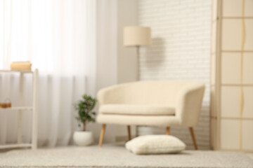 Stylish interior of light living room with comfortable sofa