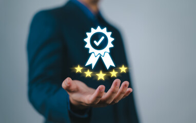Businessman holding and showing the best quality assurance with golden five stars for guarantee...