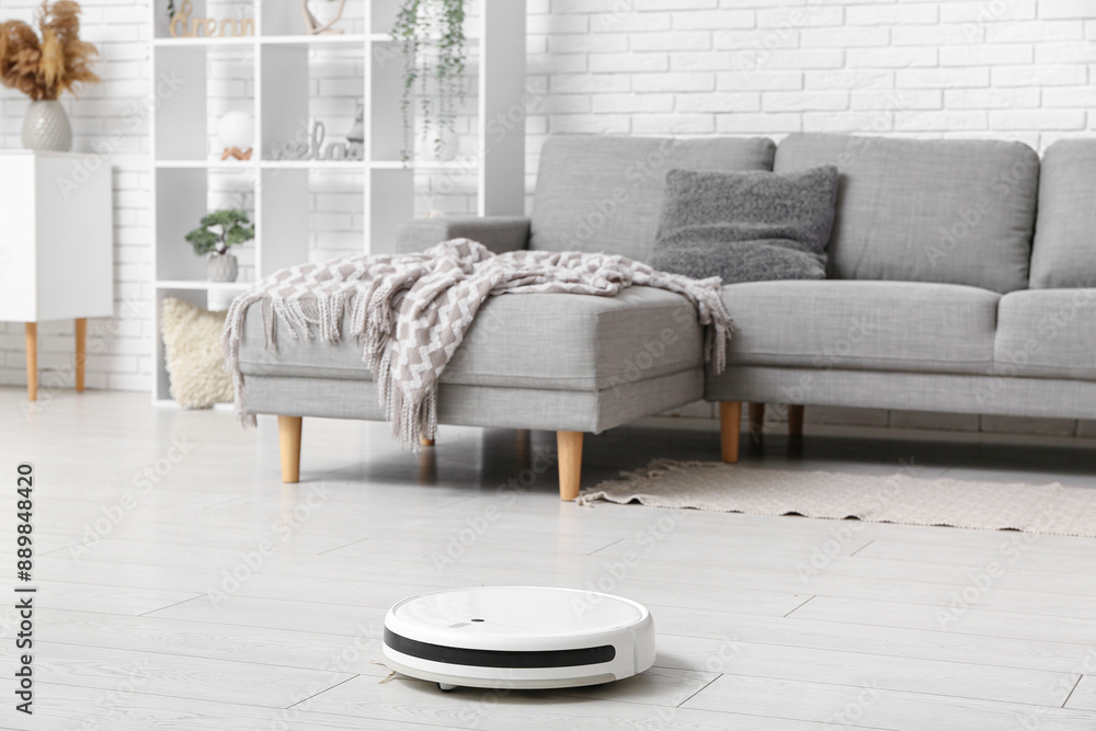 Sticker modern robot vacuum cleaner on floor at home