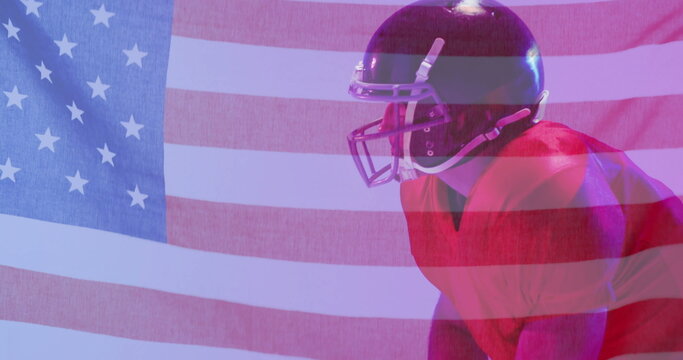 Image of caucasian american football player kneeling and flag of usa - Powered by Adobe