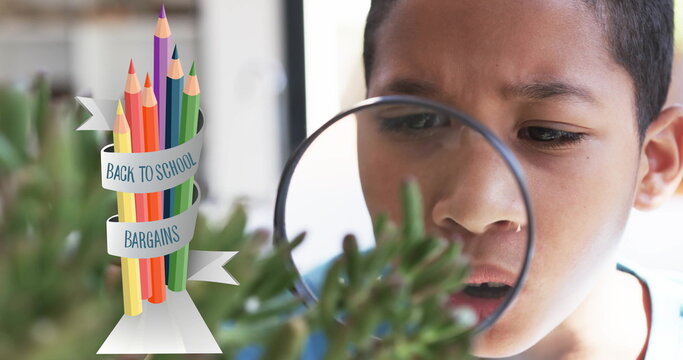Examining plant with magnifying glass, boy over back to school bargains image
