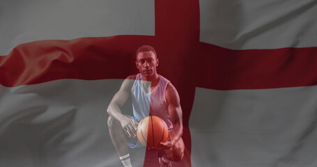 Image of flag of england over african american male basketball player