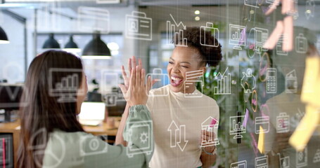 Image of currency and data processing over diverse businesswomen in office