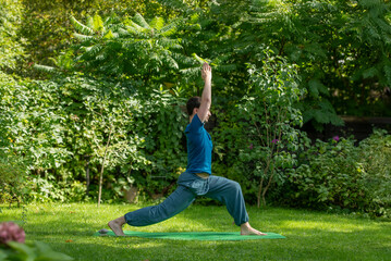 man doing yoga in nature