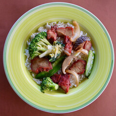Chinese style BBQ pork with vegetables and long grain rice.