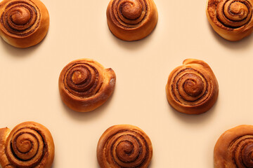 Sweet cinnamon rolls on beige background