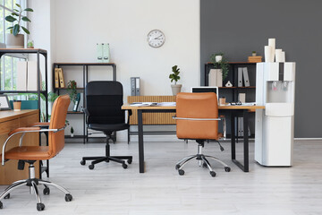 Interior of modern office with workplace and water cooler