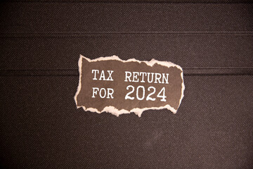 The text on the notebook is tax 2024. Reminder,