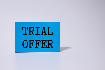 On the notebook has white paper clips and white paper with the text TRIAL OFFER.