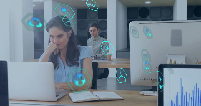 Image of ecology icons over diverse colleagues using laptop in office - Powered by Adobe