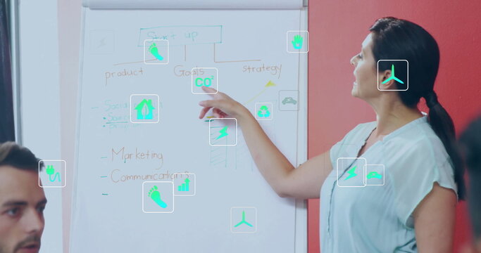 Image of ecology icons over diverse colleagues at meeting in office