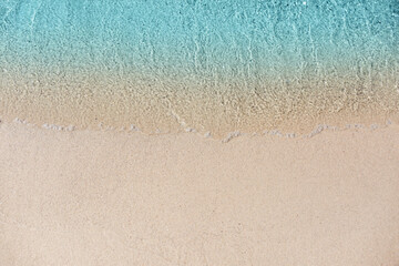 Sea waves rolling on beautiful sandy beach, top view. Summer vacation