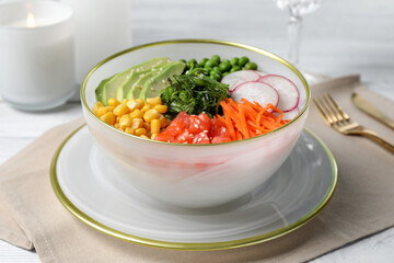 Delicious salad with salmon and vegetables served on grey table