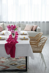 Beautiful table setting with pink peonies in dining room