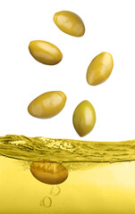 Green olives falling into cooking oil on white background
