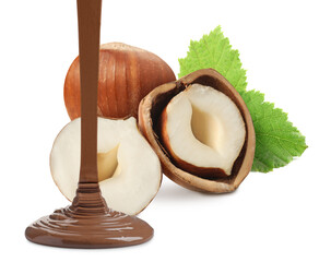 Pouring sweet chocolate onto hazelnuts against white background