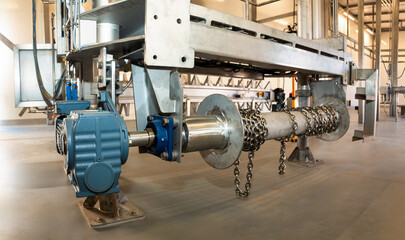 industrial chain pulley with electric motor and reduction speed gearbox in a factory