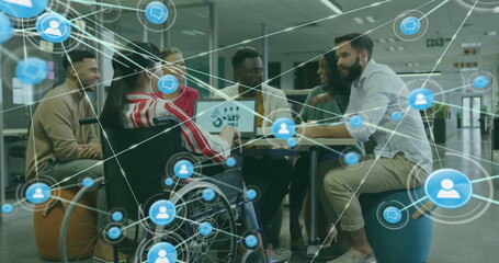 Image of network of connections with icons over disabled and diverse colleagues at meeting