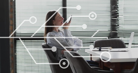 Image of circuit board and data processing over caucasian businesswoman in office