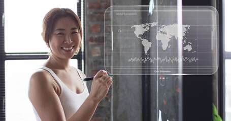 Image of world map and data processing over asian businesswoman in office